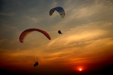 
Paragliders silhouette at sunset