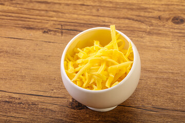 Shredded yellow cheese in the bowl