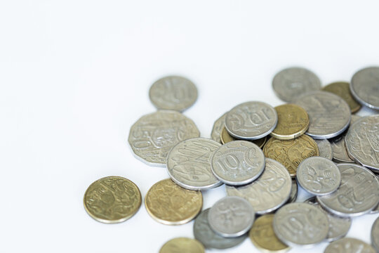 Scattered Australian coins on white