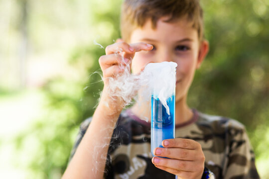 6school kid doing science experiment with dry ice, water and soap