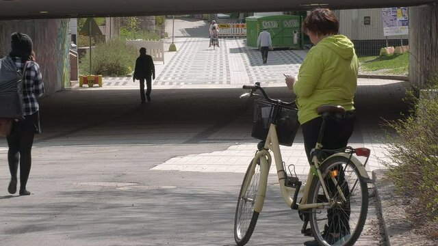 Helsinki.Finland-May 16.2021: Idyllic shot of a middle aged lady typing on her phone in Helsinki Finland showing the living conditions in the city.