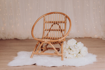 A vintage chair for a toddler to sit during a photo session in a photo studio