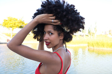 beautiful young afro american woman doing different poses and gestures on camera. She wears in her...