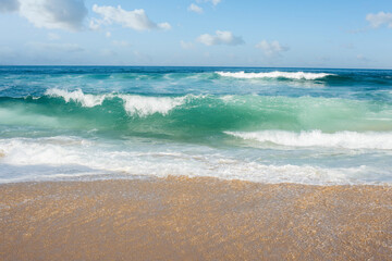 Fototapeta na wymiar waves falling on the sunny beach