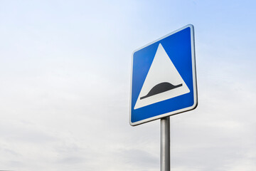 road sign speed bump on sky background, copy space