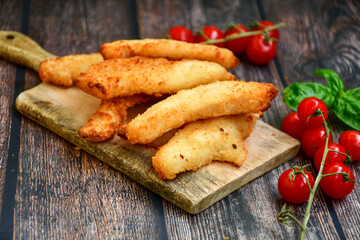 
 Crispy  deep fried home made    chicken strips Breaded  with  almond flour chicken  breast fillets  with chilly peppers and fresh   basil on wooden rustic background. Ketogenic diet food