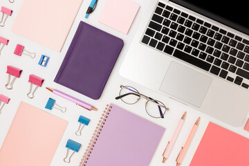 Layout of office supplies and laptop on a white background. Neat equipment concept.