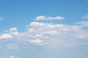 Blue sky background with blossoming white clouds