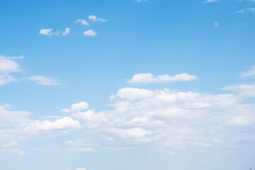 Blue sky background with blossoming white clouds