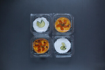 Delivery food sweet cakes top view on grey background