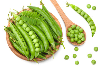 Fresh green pea pods in wooden bowl isolated on white background. clipping path. top view
