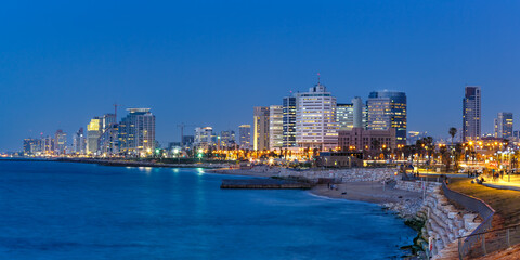 Tel Aviv skyline panorama in Israel blue hour night city sea skyscrapers