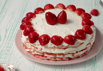 selective focus. Strawberry pie garnished with fresh strawberries. Homemade strawberries cake made from meringue cake and cream with strawberries. Decorated with icing and berries