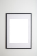 Mock up poster frame in interior white wall. White frame for poster or photo image on clean wall in home room or office interior