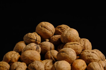 Walnut with side light in front of black background