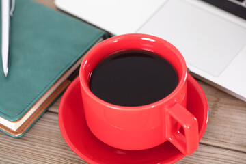 A cup of coffee next to the laptop

