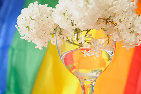 LGBT rainbow ribbon and a bouquet of flowers. Pride ribbon symbol. copy space. LGBT rights concept.