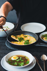 Breakfast outside. Shrimp omelet for breakfast. Omelet in a frying pan for breakfast. Lunch for a man. Fried omelet with vegetables. Summer food on the street. Egg soup. Regular food. Diet. Bouillon
