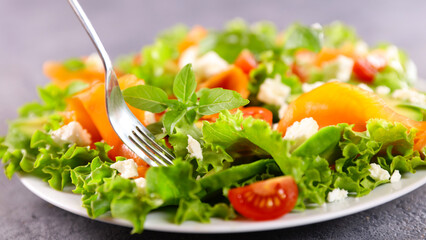 vegetable salad with smoked salmon,  tomato and feta cheese