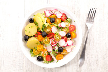 vegetable salad with potato, radish, tomato and olive