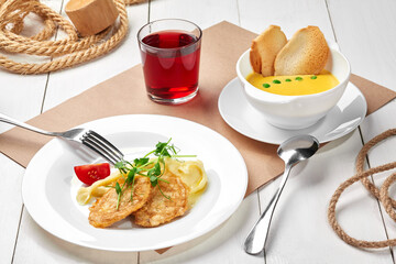 Pea cream soup, mashed potatoes with fried chicken fillet and berry compote