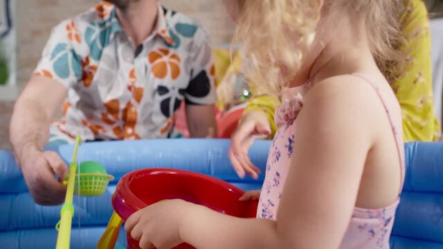 Close up video of family playing with little girl.  Shot with RED helium camera in 8K.