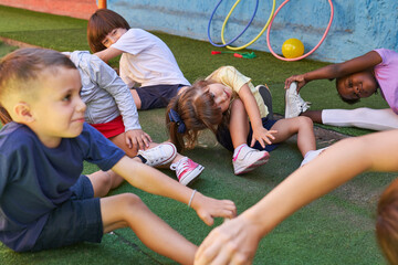 Children doing gymnastics together with an educator