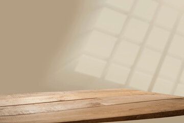 background with reflection on the wall with empty wooden table. For display mounting