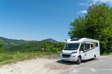 Campervan on deserted place with view on the Italian mountains