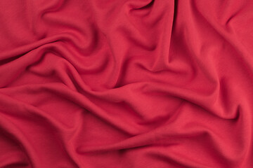 Background from red monochrome cotton fabric. Close up texture of the fabric is useful as a background.