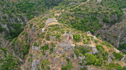 Fototapeta na wymiar Aerial drone photo of ruins of Byzantine Medieval ancient city of Palaiochora - old Kythira island capital built in start of Canyon leading to Kaki Lagada beach, Ionian, Greece