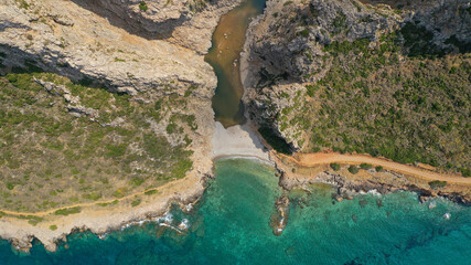 Aerial drone top down photo of scenic turquoise beach and small lake of Kaki Lagada in the end of Canyon starting from ancient city of Kythera island - Palaiochora, Ionian, Greece