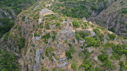 Fototapeta premium Aerial drone photo of ruins of Byzantine Medieval ancient city of Palaiochora - old Kythira island capital built in start of Canyon leading to Kaki Lagada beach, Ionian, Greece