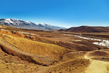 Fantastic red mountains with bright color transitions and blue clear sky in place named Mars 1, Altai Republic