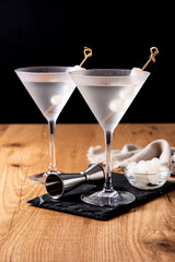 Gibson martini cocktail with onions on wooden table