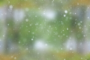 blurred snow / winter abstract background, snowflakes on abstract blurred glowing leaf background