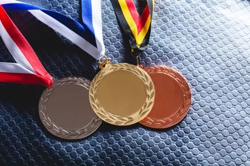 Fotobehang Gold, silver and bronze medal on velvet cushion © Photocreo Bednarek