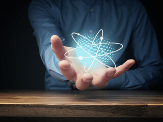 Everything is energy, businessman holding energetic ball, positive energy symbolized by atoms...