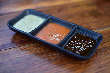 Sauce in  bowl on wood table.