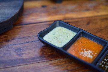Sauce in  bowl on wood table.