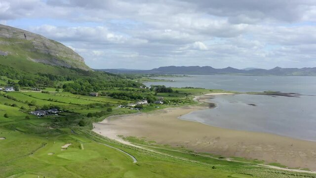 Cullenamore Beach, Strandhill, Sligo, Ireland, June 2021.  Drone descends gradually while facing south towards Tullaghan, flying over families and holidaymakers relaxing, walking and sunbathing.