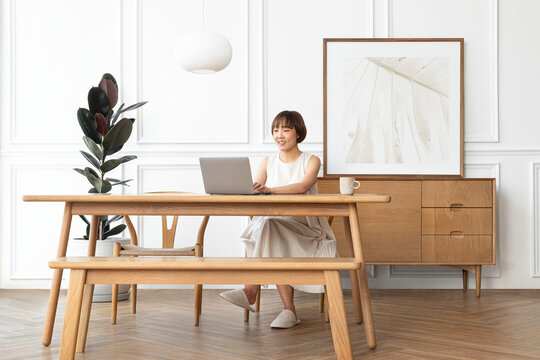 Woman working at home in a scandinavian decor living room