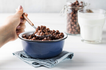 A dry breakfast of chocolate round flakes. 
