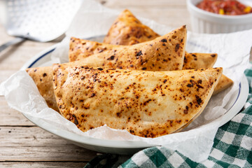 Traditional Chilean empanadas on rustic wooden table