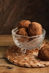 Russian chocolate cake potato, in a crystal vase, on a textured beautiful background.