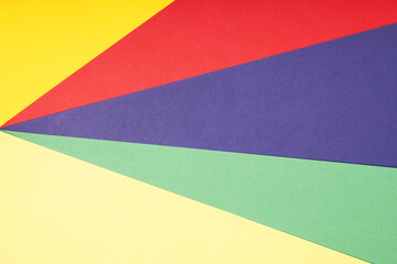 multicolor paper background in red pruple green and yellow