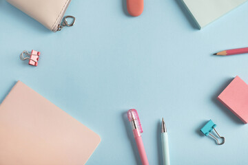 School supplies on pastel blue background. Back to school concept. Top view, flat lay, copy space, frame