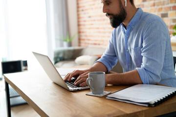 Man working on a laptop in the home office