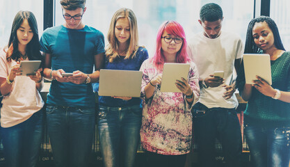 Young students using digital tablets at school
