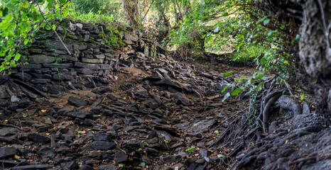 Fototapeta premium Dry river banks full of dark stones